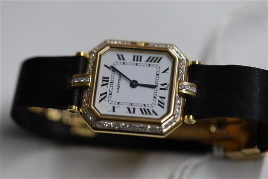 A ladys 18ct gold and diamond set Cartier quartz octagonal cased wrist watch, and Cartier box.